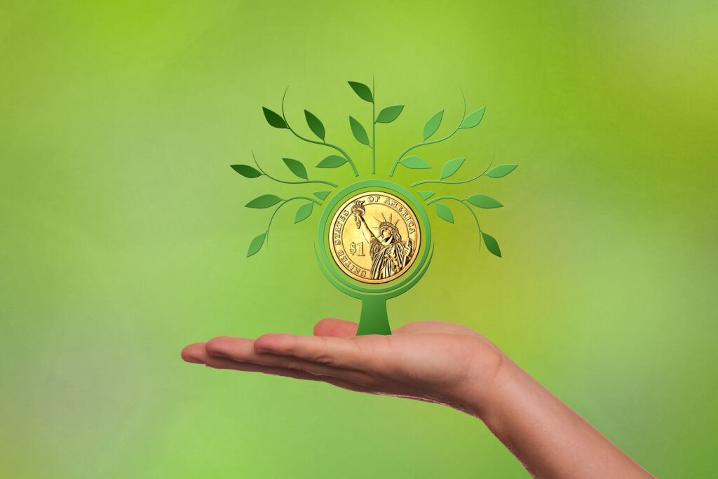 Hand holding coin with leaves coming out
