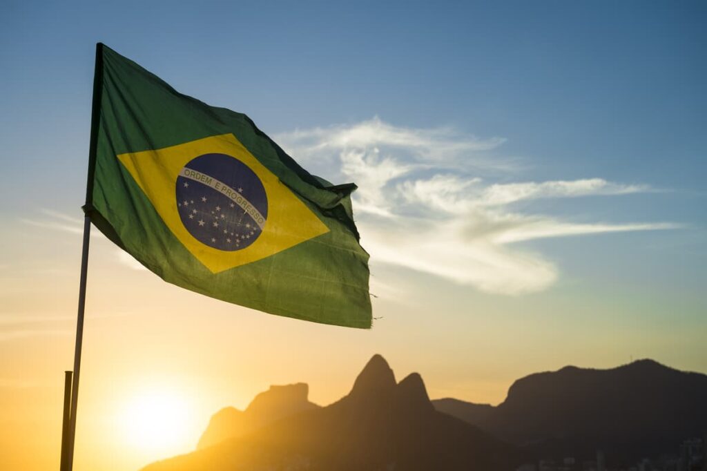 Brazil flag against sky at sunset